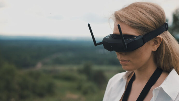 Girl puts on black FPV goggles to control the drone